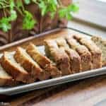 Best Banana Bread. Image of sliced loaf of soft moist banana bread on a wooden board.