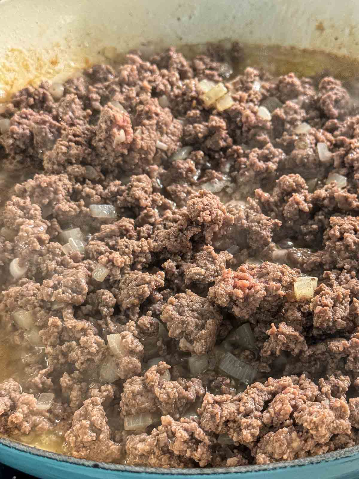 Gorund beef being browned in a pan.