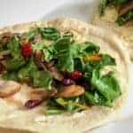 Beautiful Green Leafy Chopped Swiss Chard and Mushroom Wraps on 2 Flour Tortillas served on a white plate.