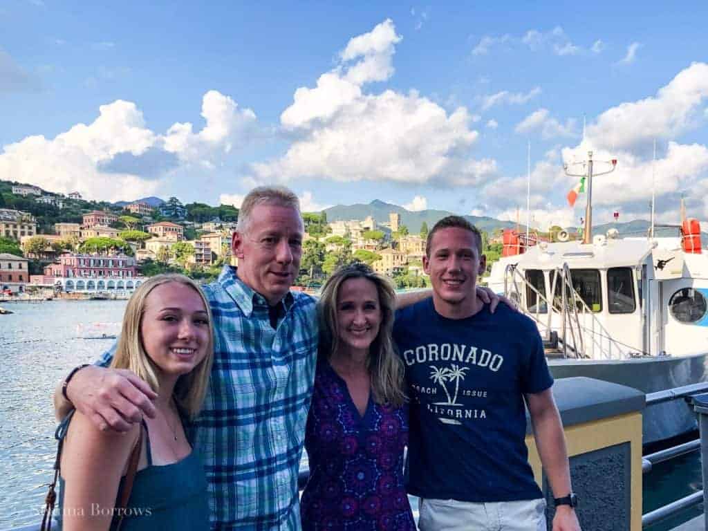 Image of Seanna's family in Italy 2019 blue sky and sea with boat in background