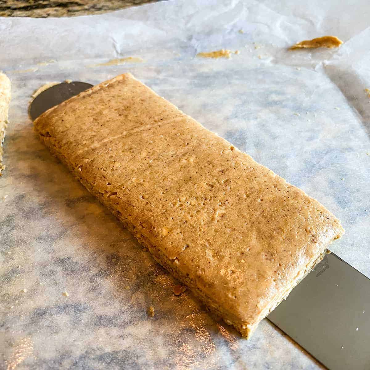 One bar lifted on a spatula set over parchment paper