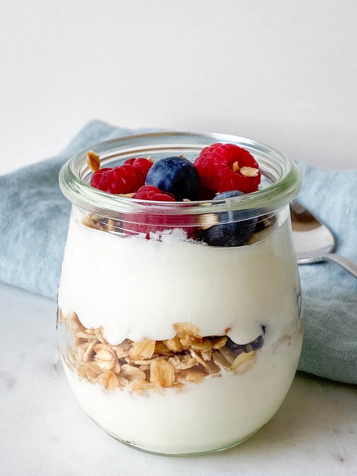 Yogurt parfait layered with honey granola, fresh berries.