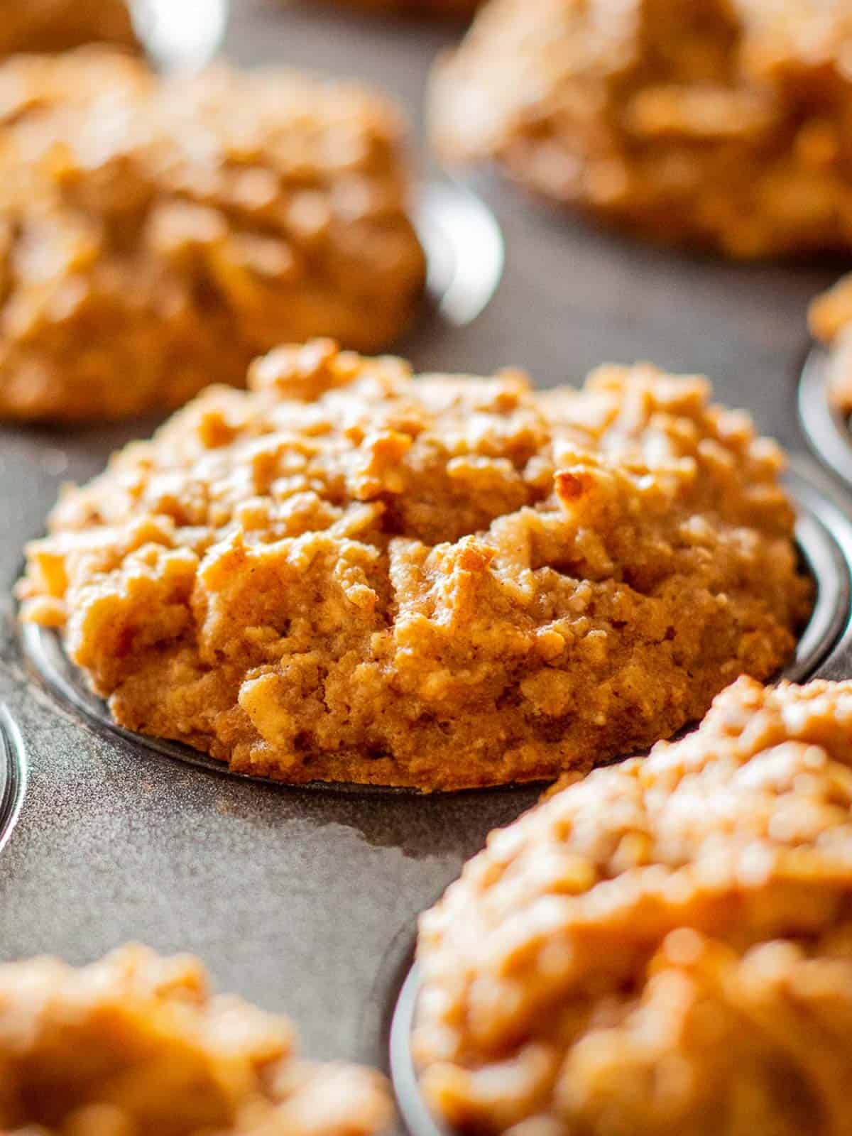 Baked Gluten Free Apple Muffins in a muffin tin.