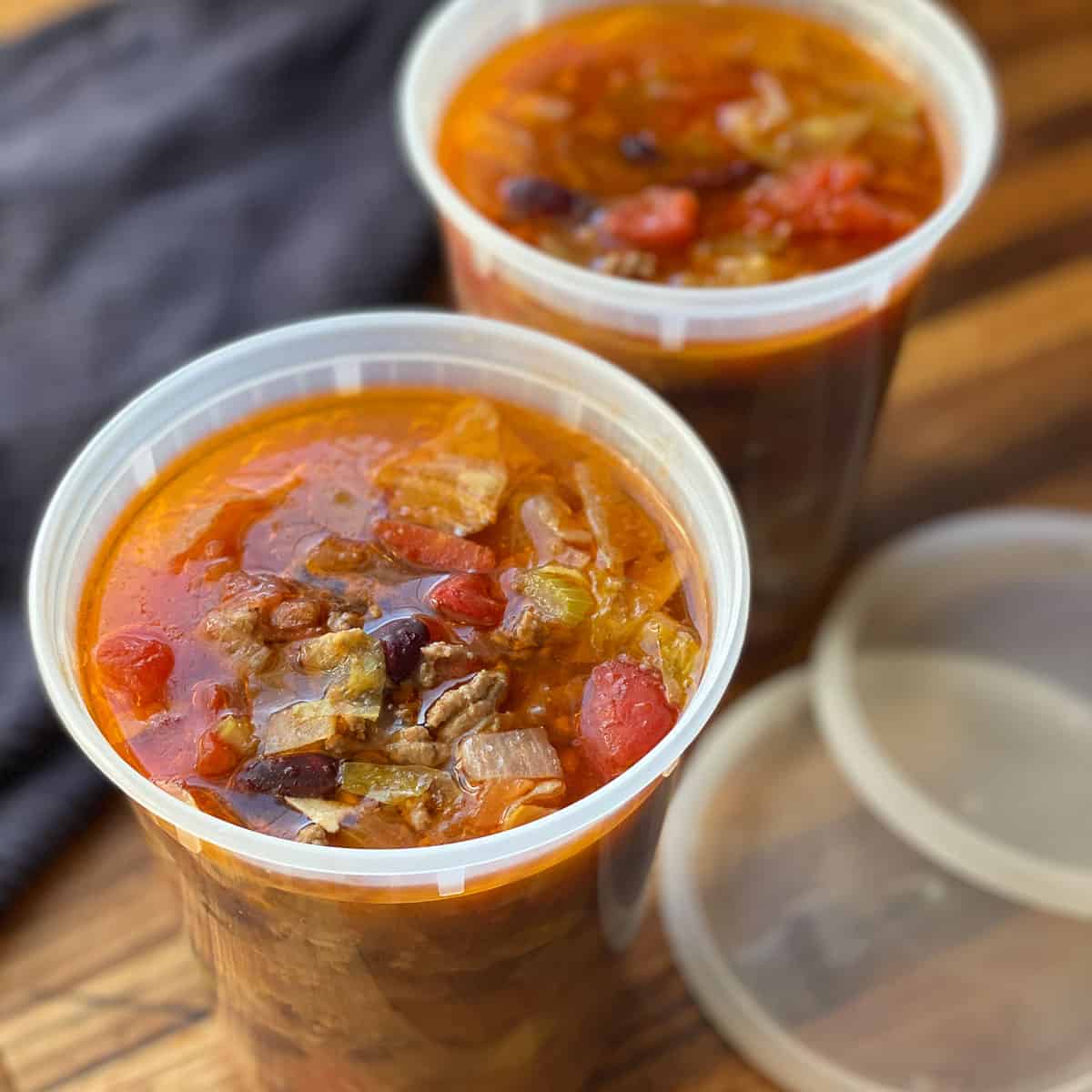 Beef and Cabbage Soup in Storage Containers with lids on side.