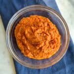 Image showing clear bowl of Pumpkin Butter on a blue kitchen towel.