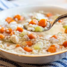 Image of a bowl of Instant Pot Chicken Soup with a spoonful raised.