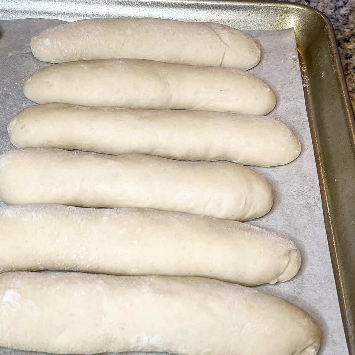 Image showing risen breadsticks ready for the oven.