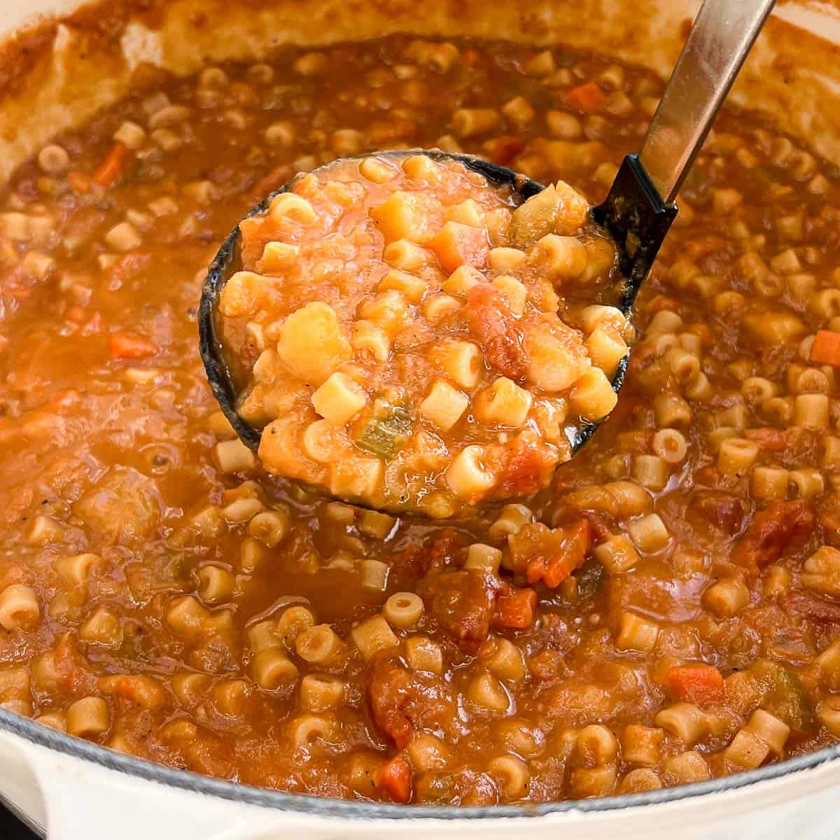 Image showing ladleful of Pasta Fagioli over a pot of soup.