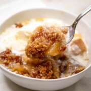 Image showing a spoonful of delicious Apple Crisp raised from a bowl.