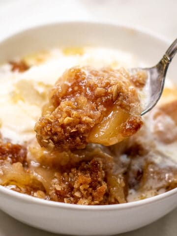 Image showing a spoonful of delicious Apple Crisp raised from a bowl.