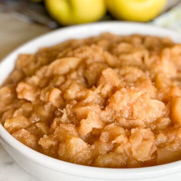 Chunky Applesauce with Golden Delicious Apples in background.