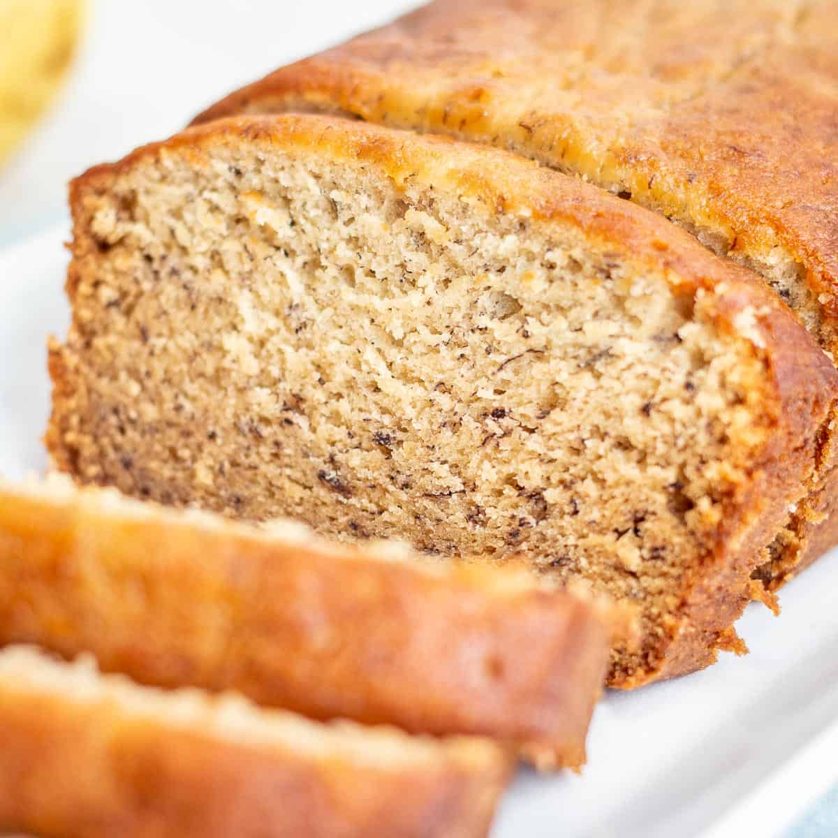 Old Fashioned Banana Bread loaf with slice shown.
