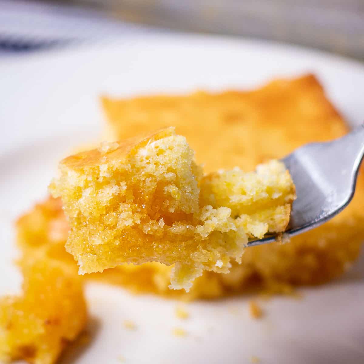 Bite shot of Best Jiffy Cornbread Recipe showing the delicious honey butter bottom.