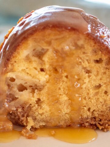 Slice of Old Fashioned Apple Cake with Bourbon Glaze.