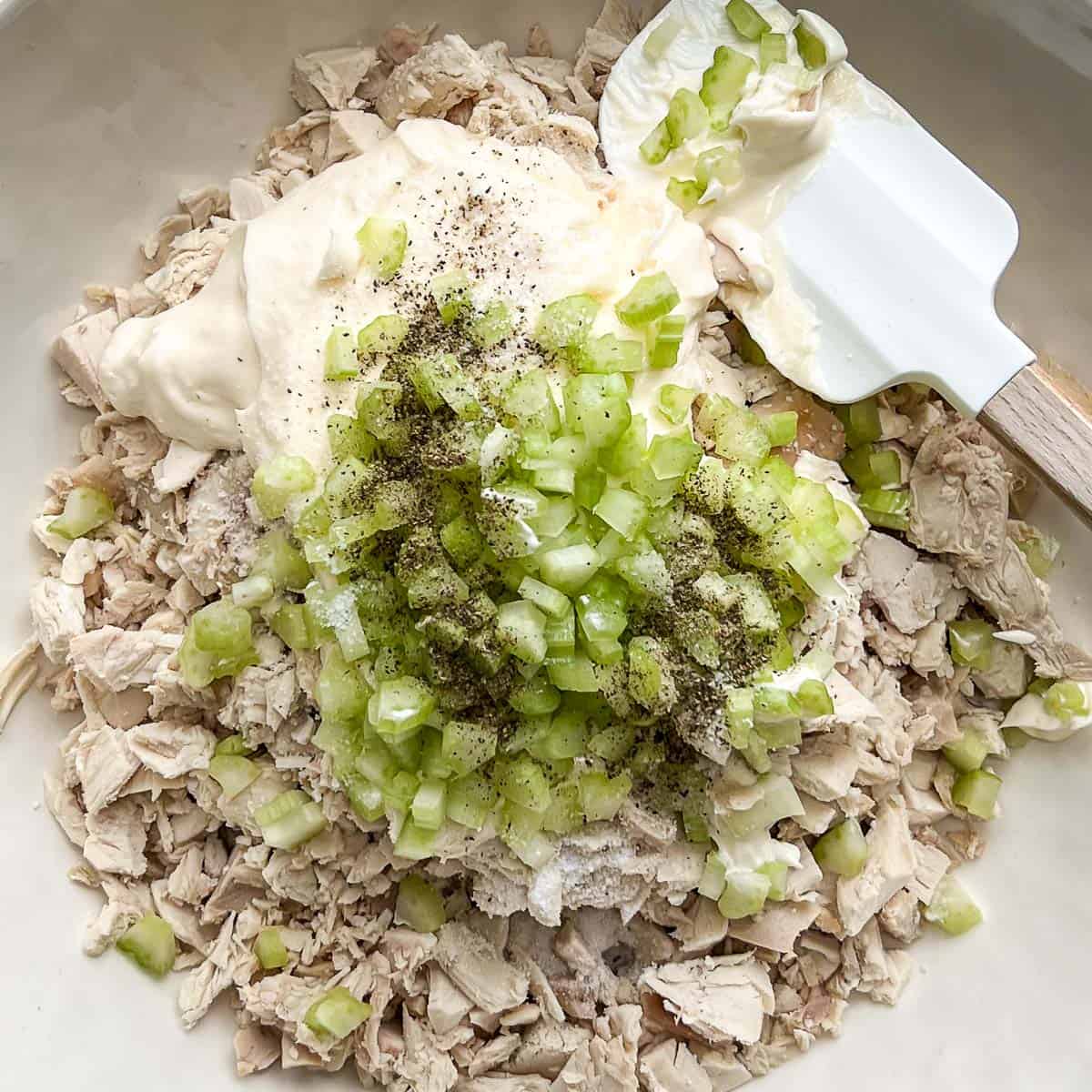 Ingredients for Classic Chicken Salad in a bowl uncombined.