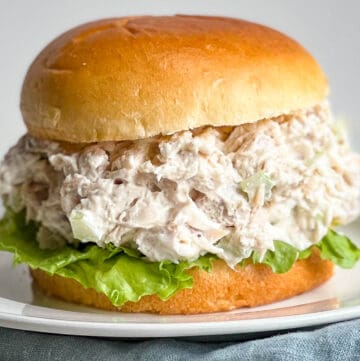 Classic Chicken Salad Sandwich on a brioche bun and garnished with lettuce.