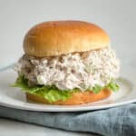 Chicken salad sandwich on brioche roll with lettuce.