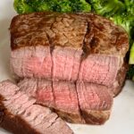 Filet Mignon sliced showing perfect medium rare interior.