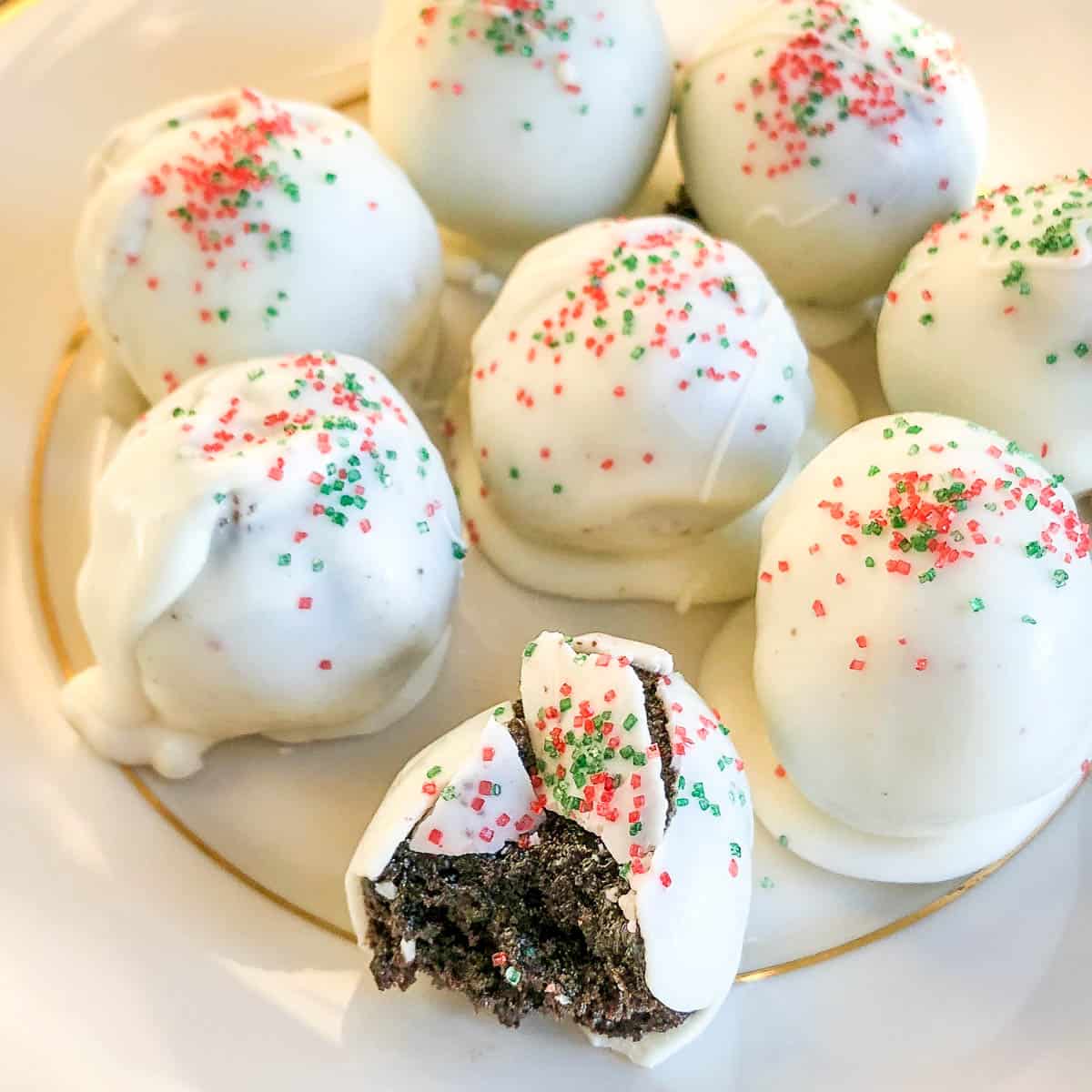 Oreo Cookie Balls dipped in white chocolate and sprinkles.