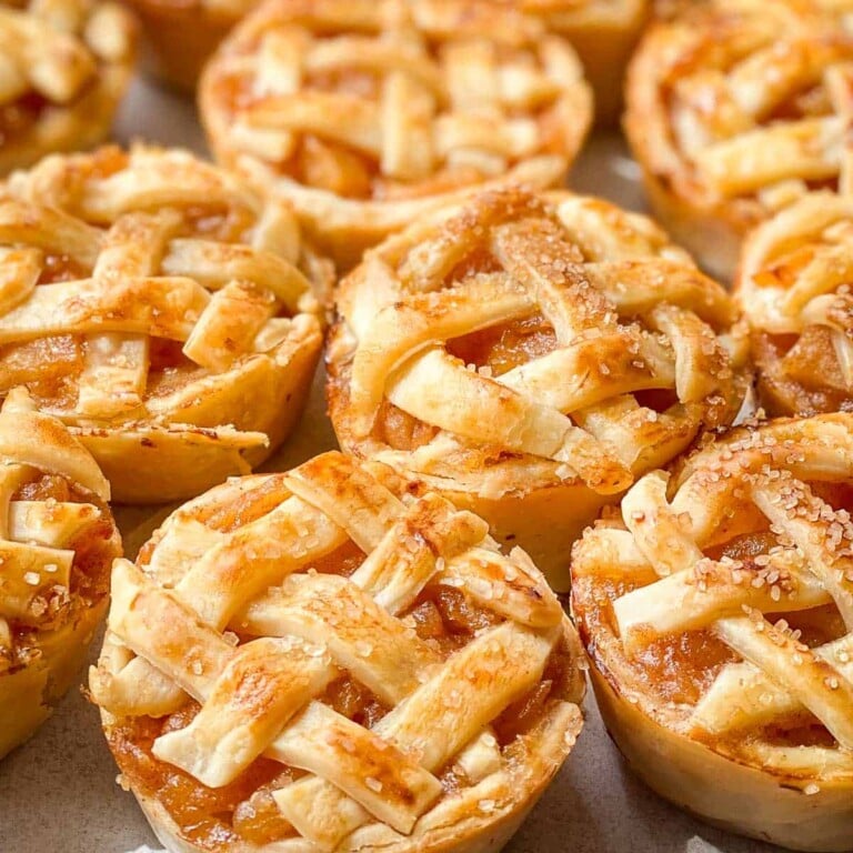 Mini Apple Pies with a lattice top on a plate.