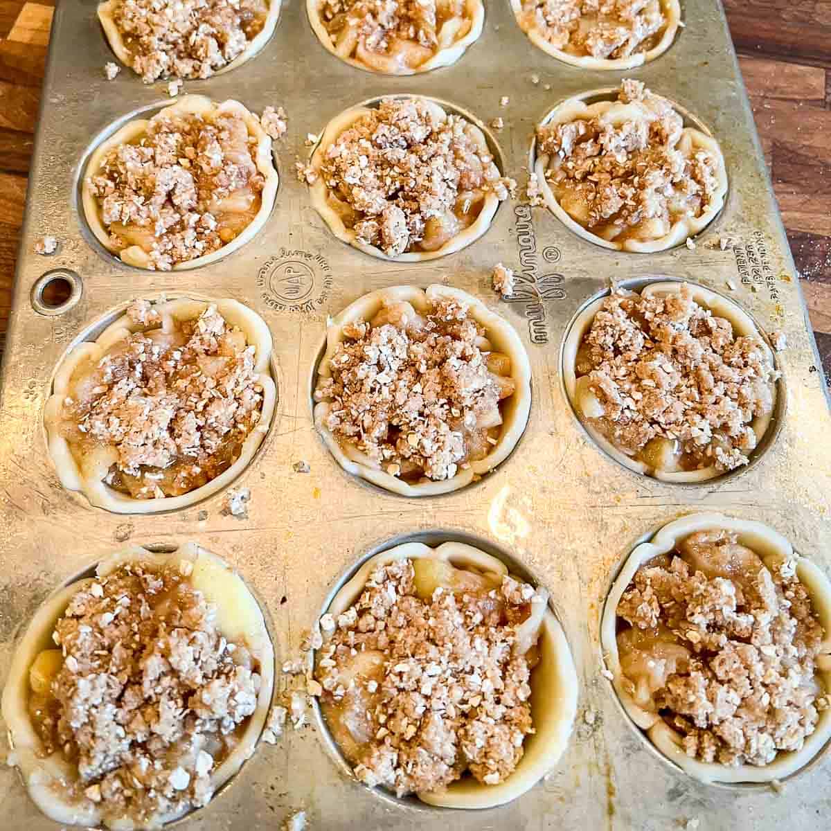 Mini apple pies with crumb topping.