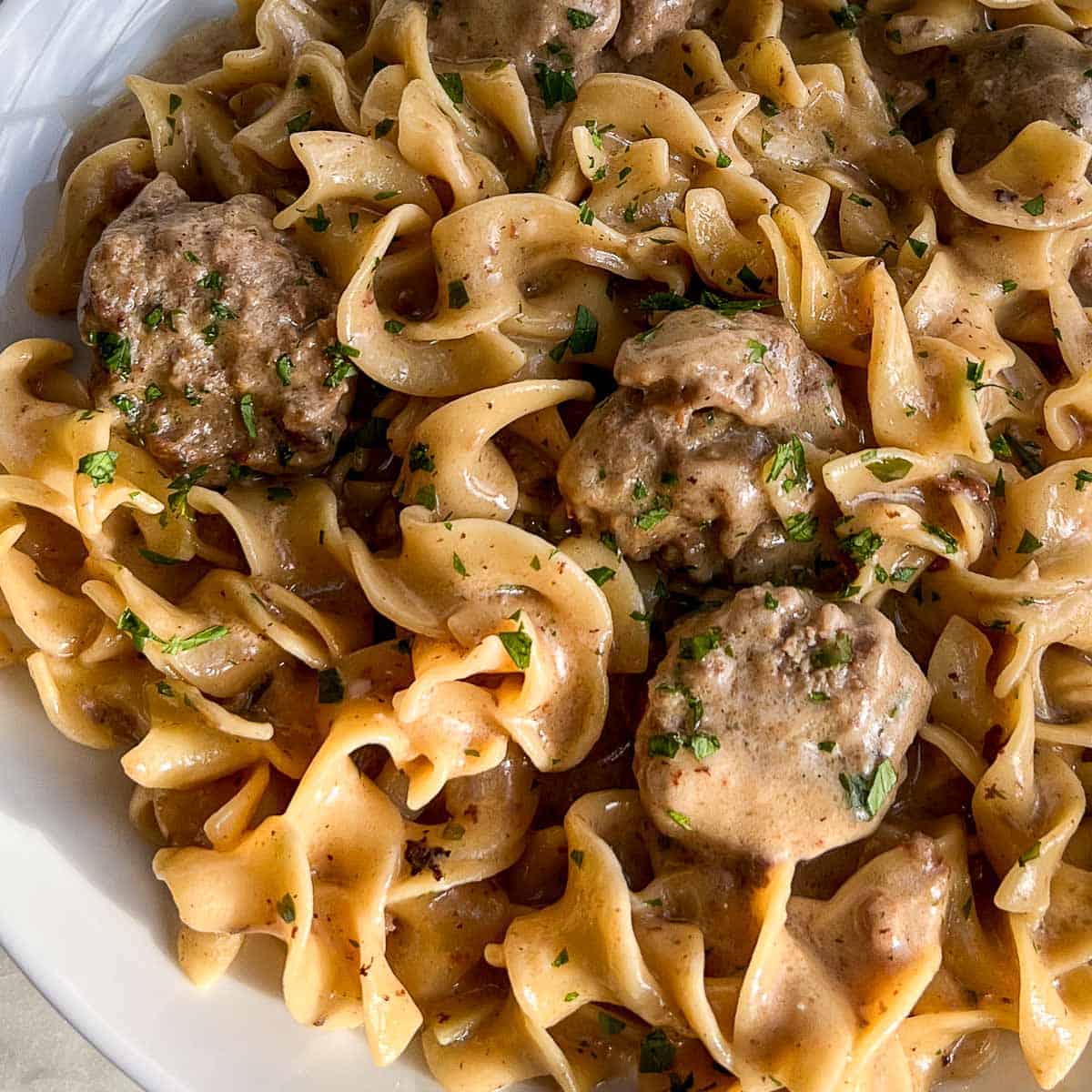 One pot Swedish meatballs and gravy on a white plate.