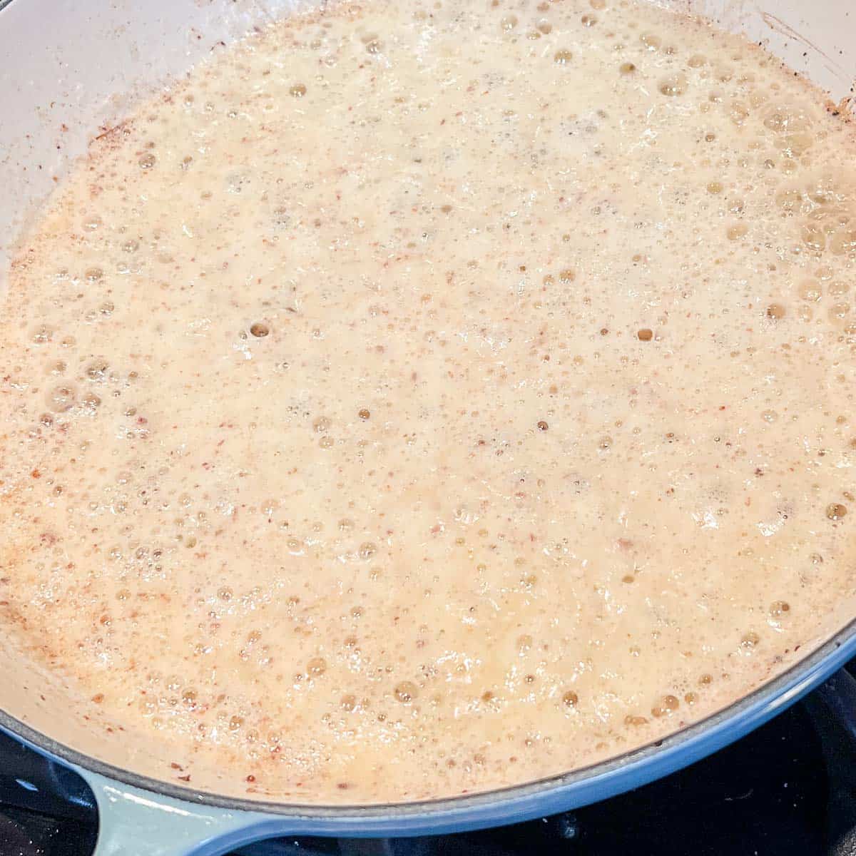 A roux bubbliing in a pan.
