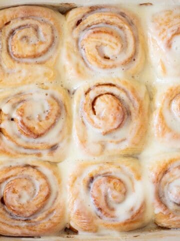 A whole pan of cinnamon rolls with icing.