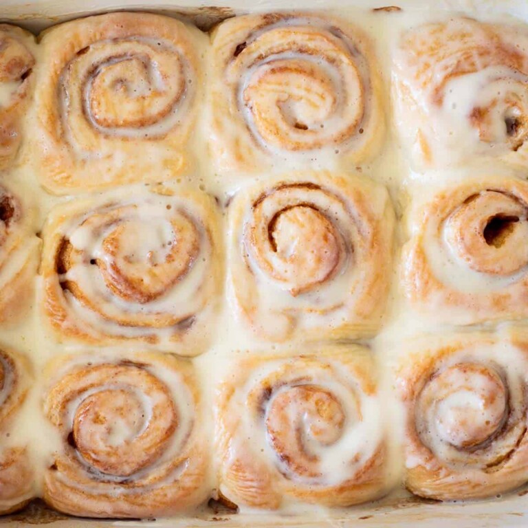 A whole pan of cinnamon rolls with icing.