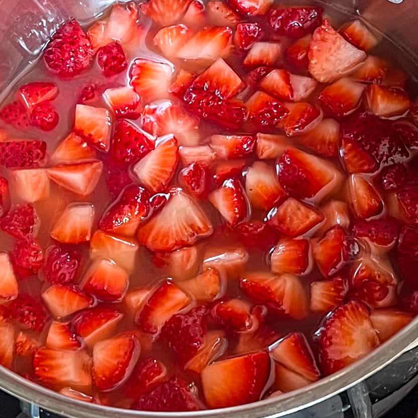 Chopped strawberries simmering in simple syrup.