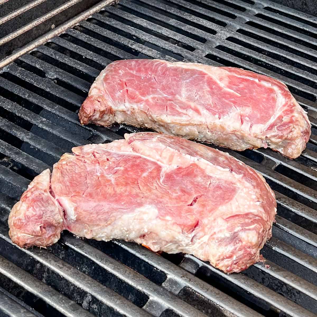 Ribeye steaks just ready to turn over.