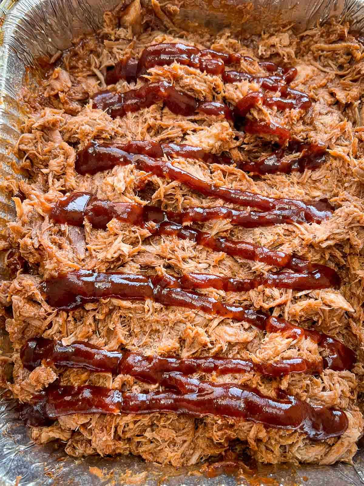 Perfect pulled pork with BBQ sauce on top.