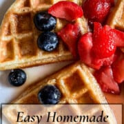 Three pieces of a Homemade Waffle on a white place with strawberries and blueberries and a little maple syrup in the wells of the waffle with a title banner across the bottom.