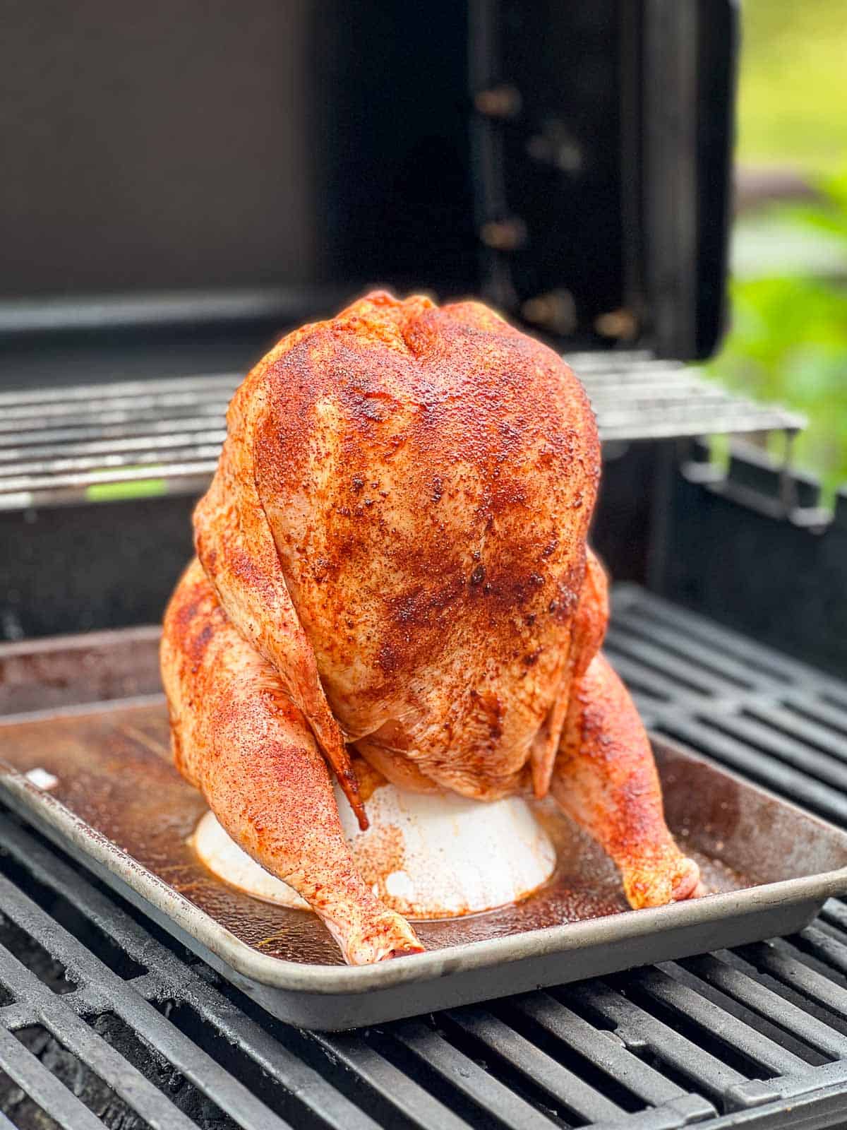 Beer can chicken prepared and placed on the grill.