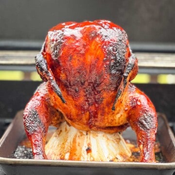 Grilled whole beer can chicken on the grill.