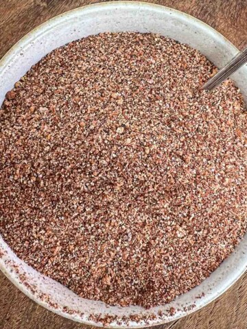 The best dry rub for ribs in a small white bowl with little spoon.