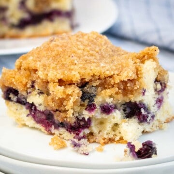 A piece of Blueberry Buckle on a white plate.
