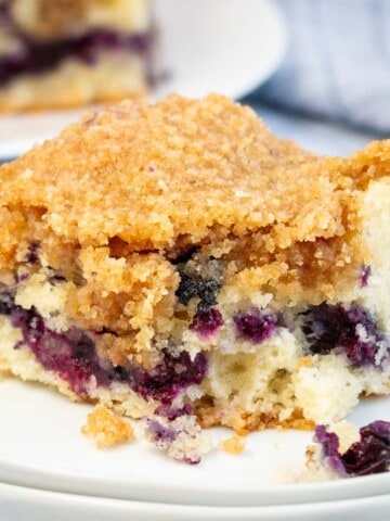 A piece of Blueberry Buckle on a white plate.