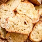 Crostini piled in a brown basket.