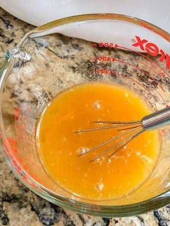 Mixture of bright yellow eggs, and wet ingredients.