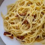 Spaghetti carbonara on a white plate.