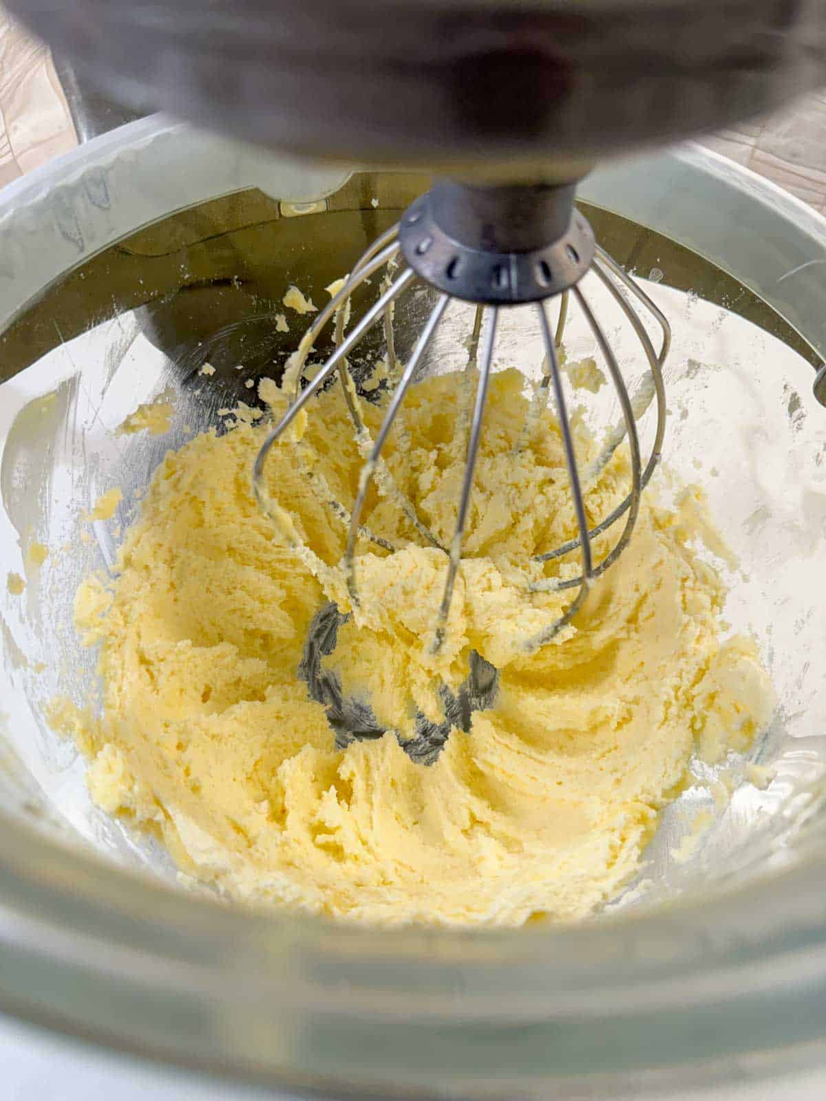 Creamed butter and sugar in a stand mixer bowl with wire whip attachment.