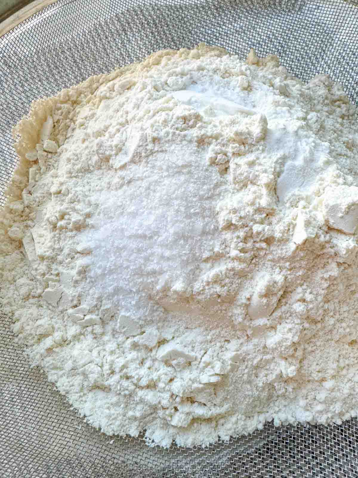 Dry ingredients for banana muffins in a sifter.
