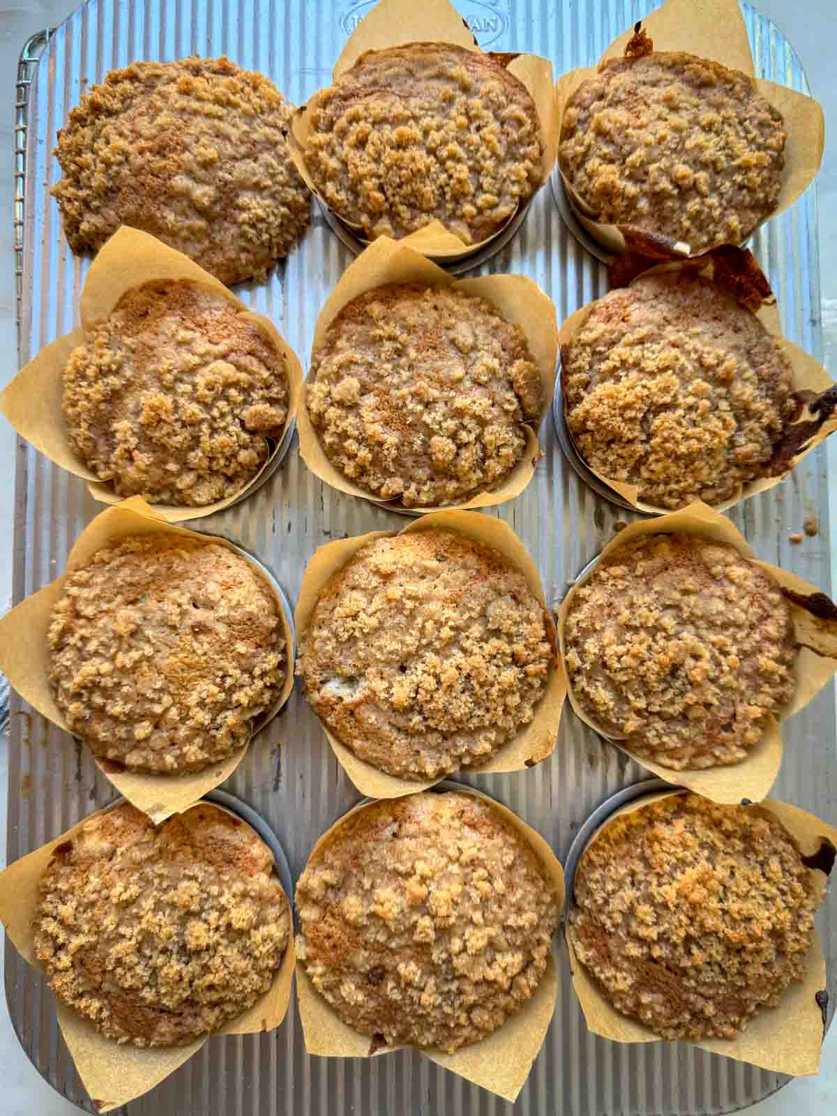 Freshly baked banana muffins in a muffin tin.