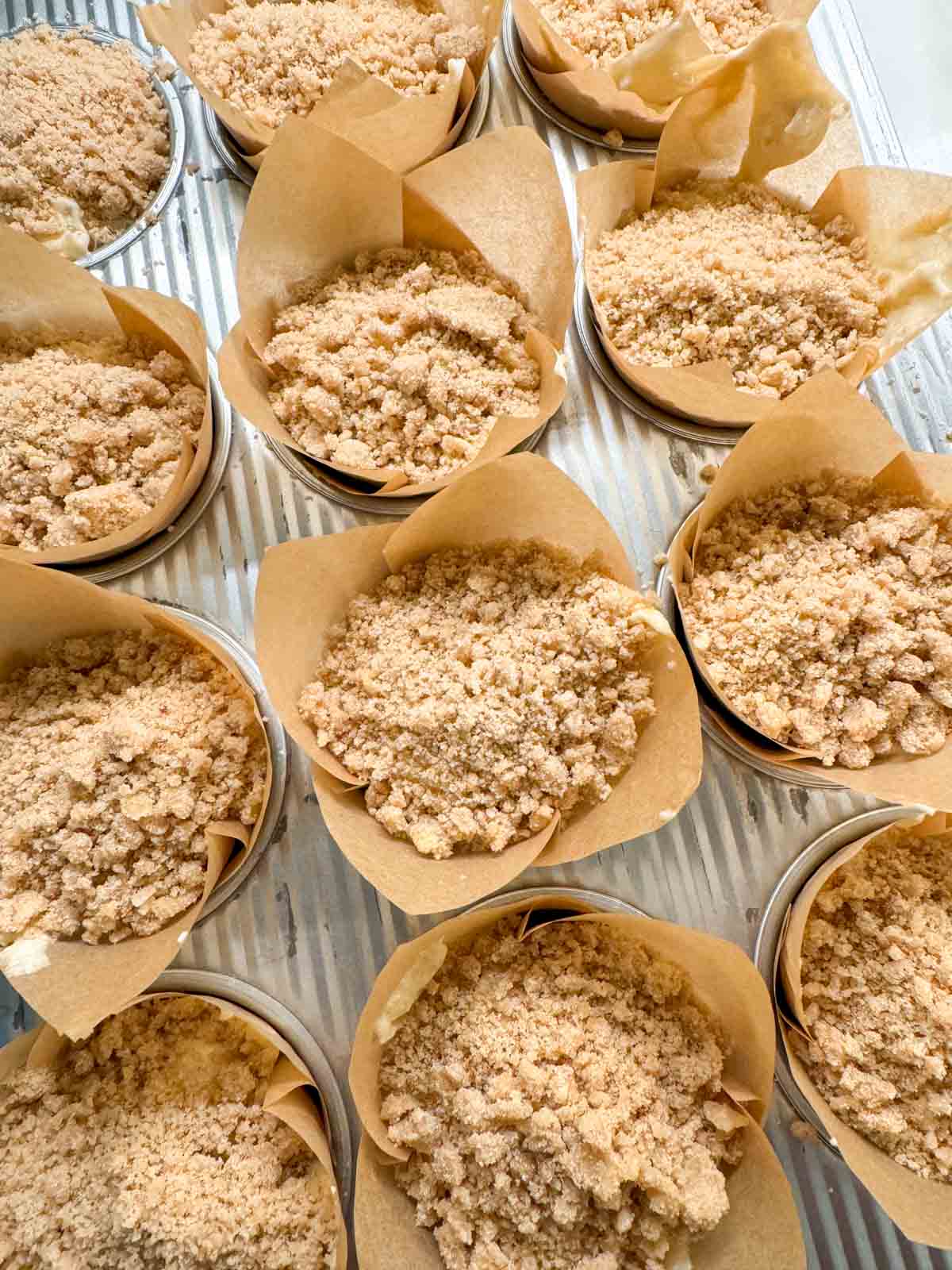 Banana muffins in a muffin tin prepared for the oven.