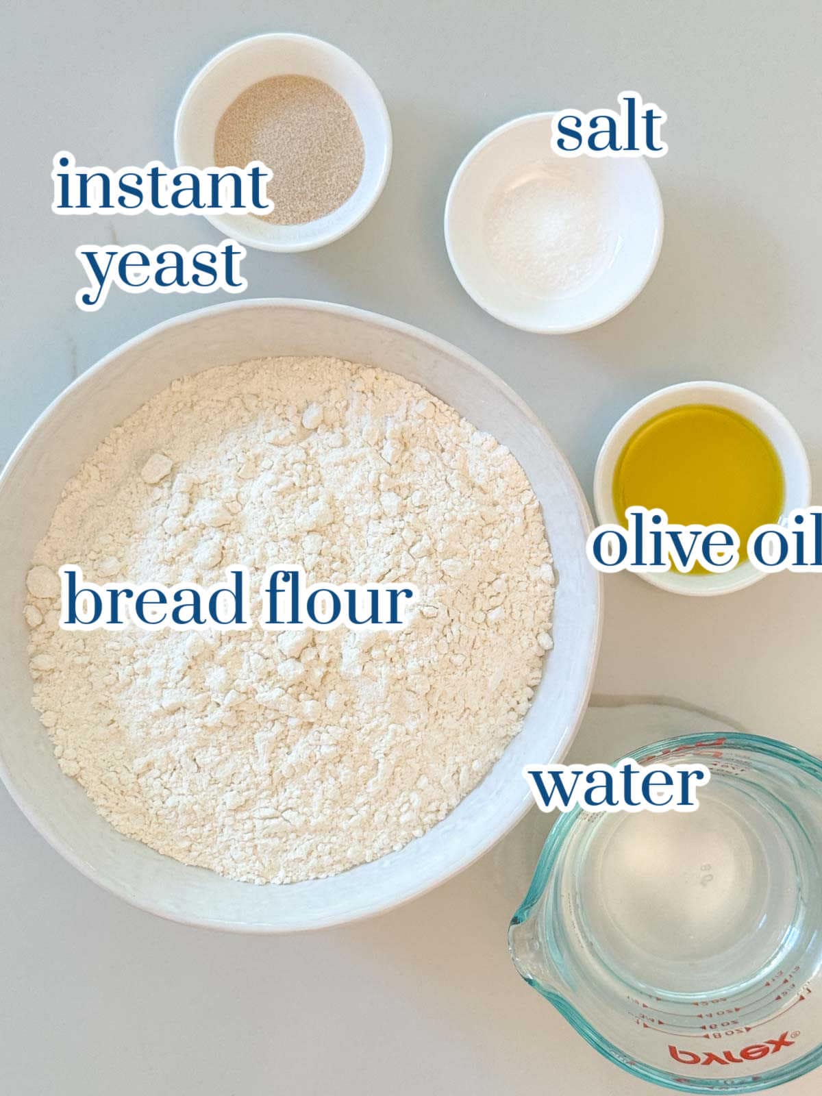 Individual ingredients for homemade focaccia bread recipe.