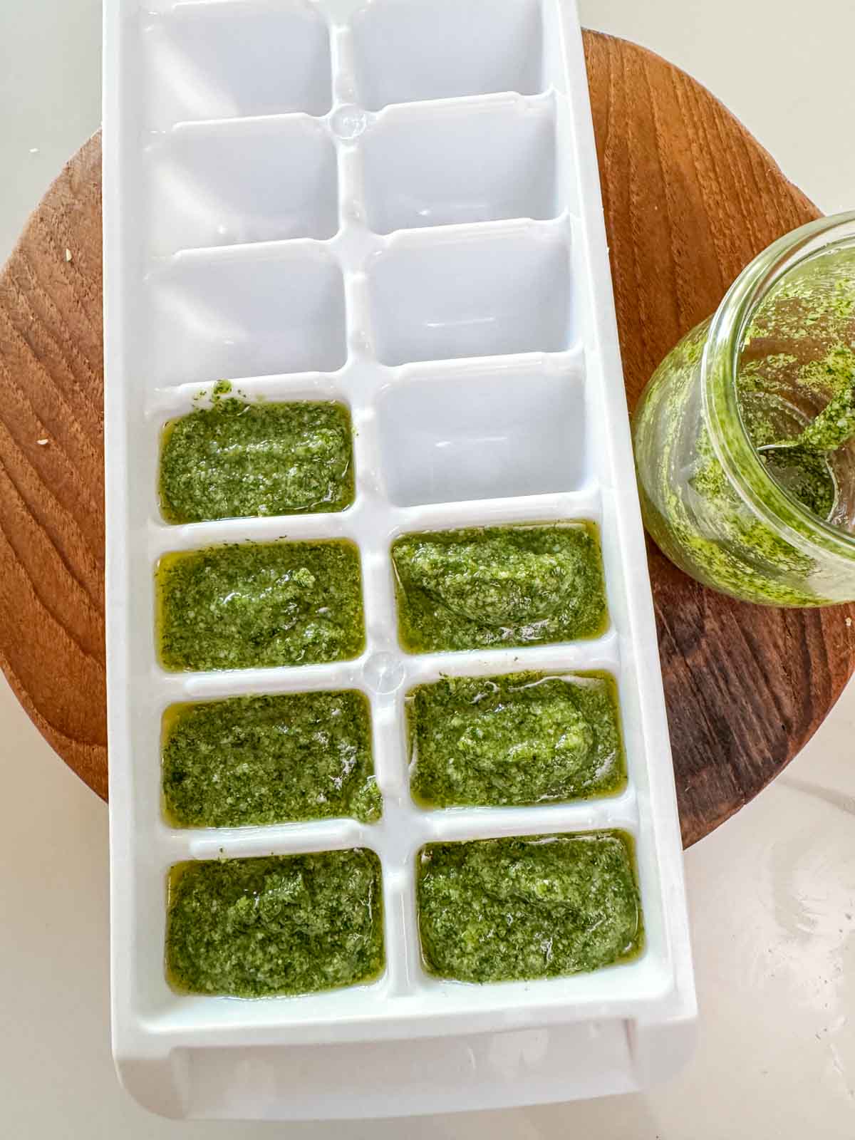 Pesto in an ice cube tray ready to be frozen for safe storage.