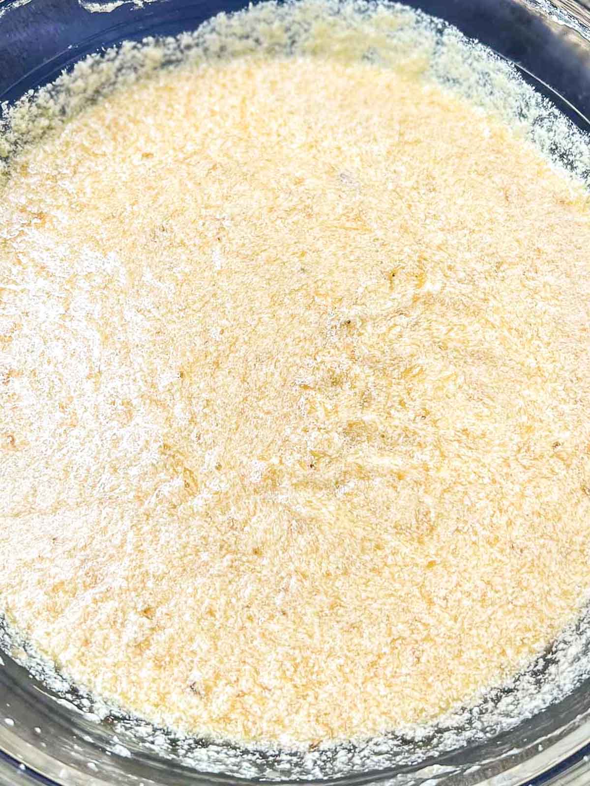 A bowl full of mixed wet ingredients for banana bread recipe.