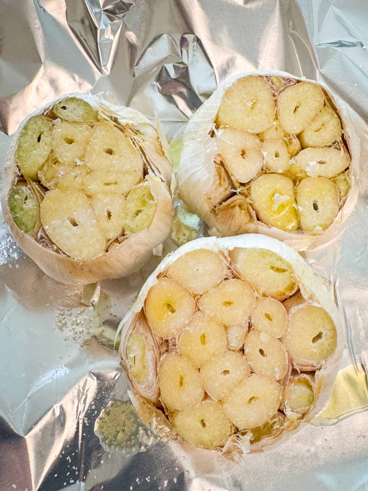 Garlic drizzled with olive oil on foil before going into the oven.