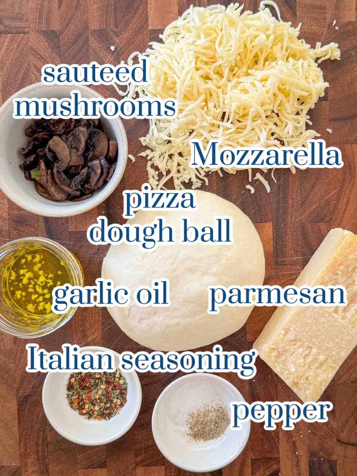 Ingredients for homemade white pizza: mozzarella cheese, sautéed mushrooms, garlic olive oil, Italian seasoning, and pizza dough.